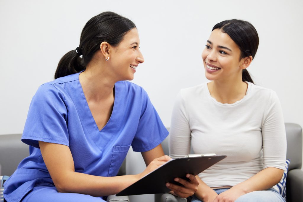 nurse and woman talking at a Lasik consultation